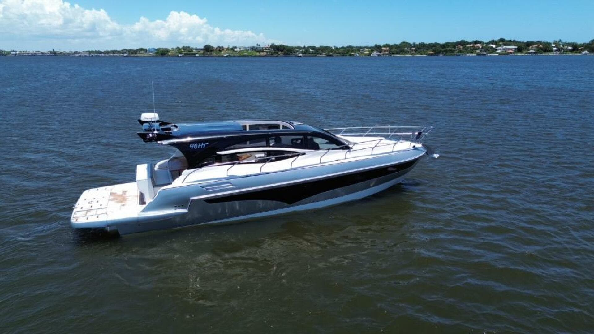 Luxury yacht Real 40 HT 2025 model cruising on a serene blue lake.