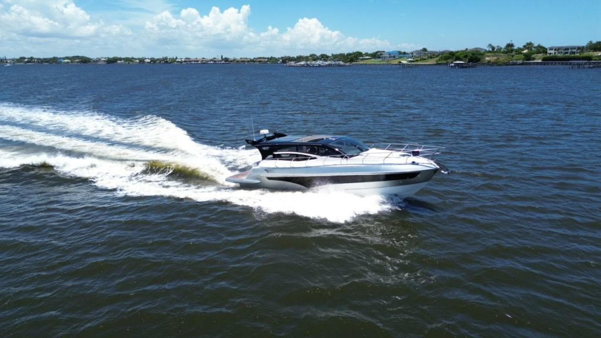 Luxury yacht Real 40 HT 2025 cruising on open water under clear skies.