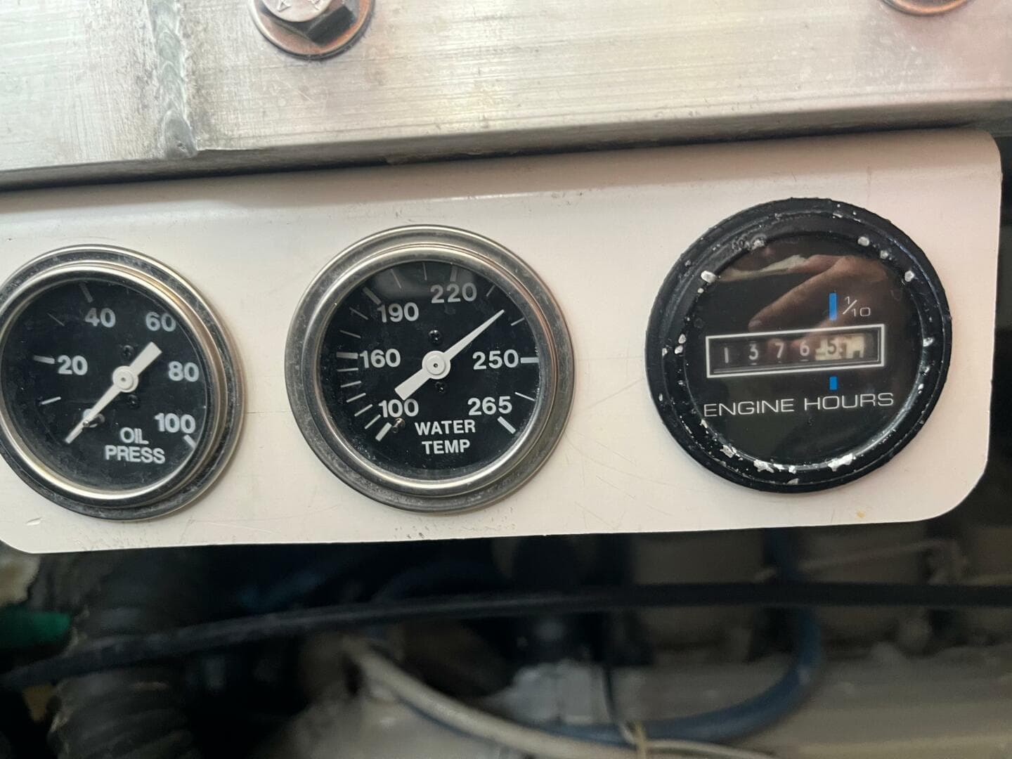 Gauges on a 2000 Carver 396 Motor Yacht showing oil pressure, water temperature, and engine hours.