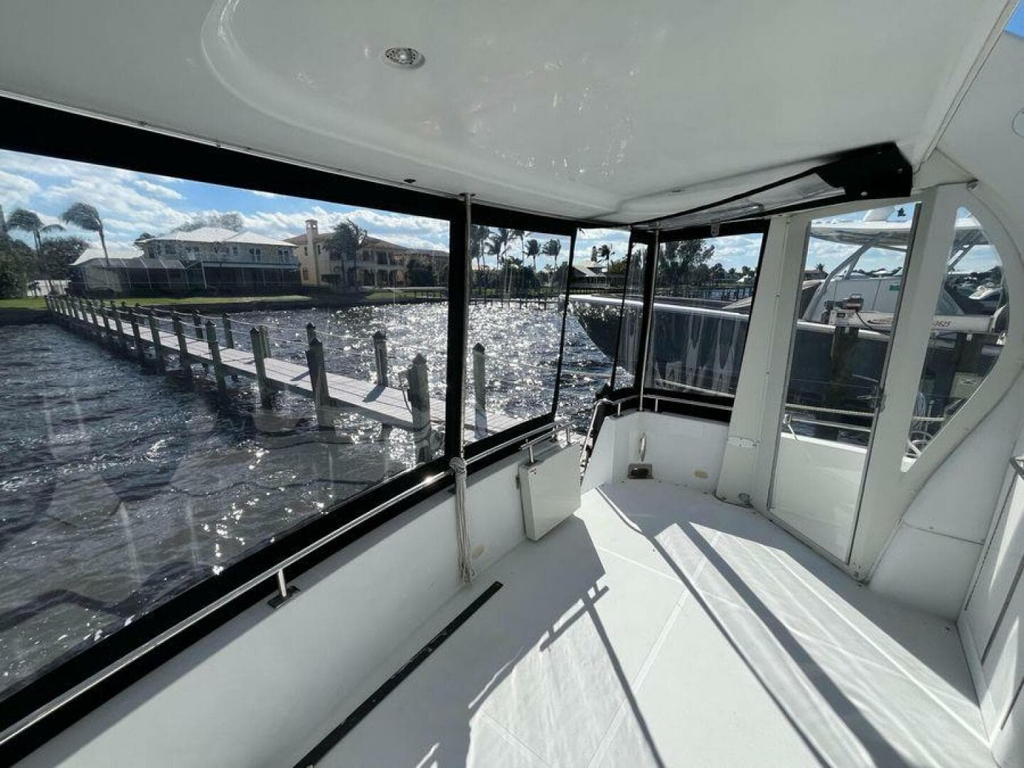 2000 Carver 396 Motor Yacht interior with marina view through large windows.