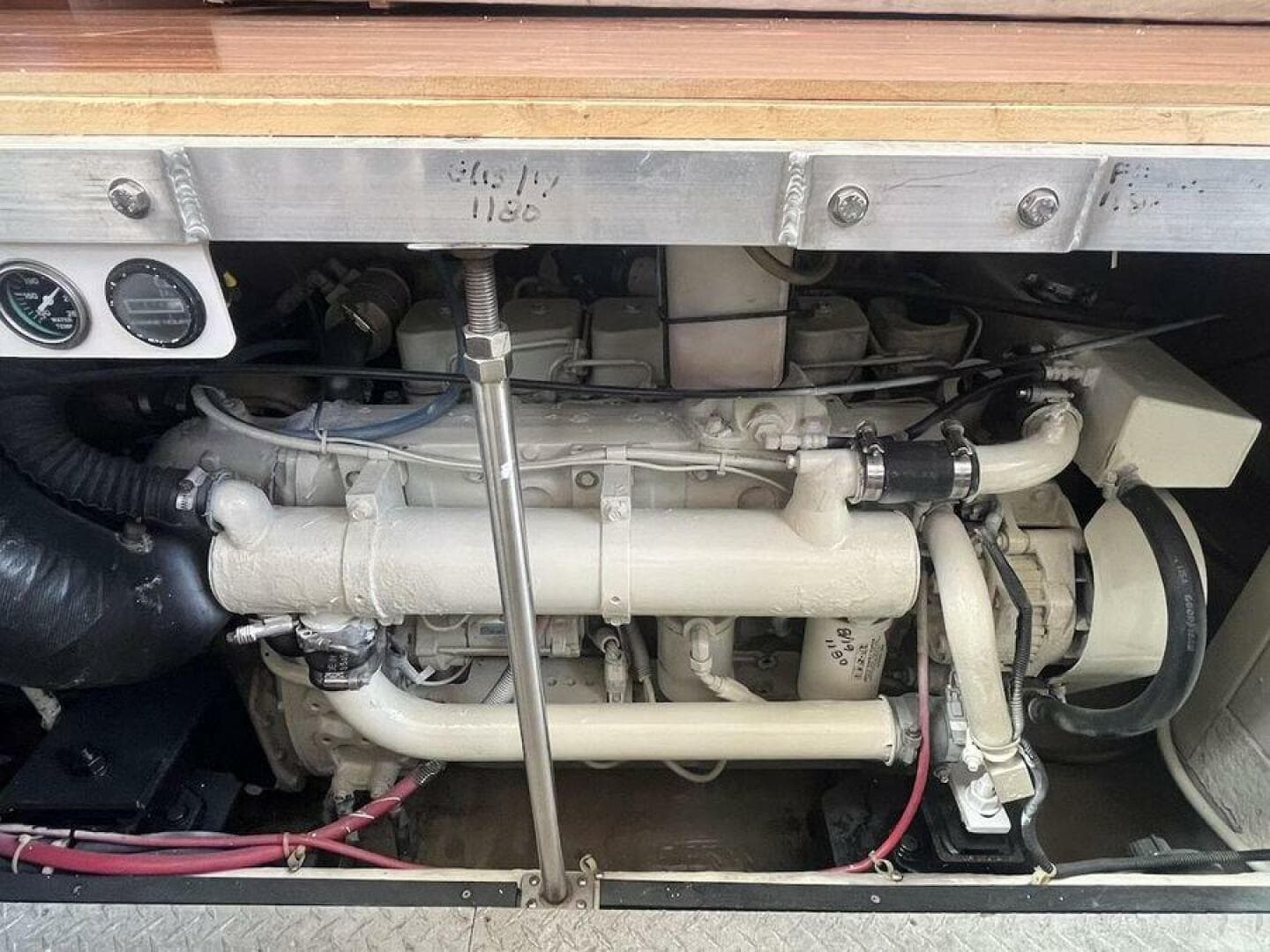 Engine compartment of a 2000 Carver 396 Motor Yacht, showcasing mechanical components and gauges.