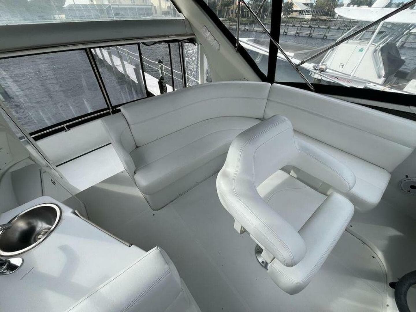 Interior of 2000 Carver 396 Motor Yacht with white seating and windows.