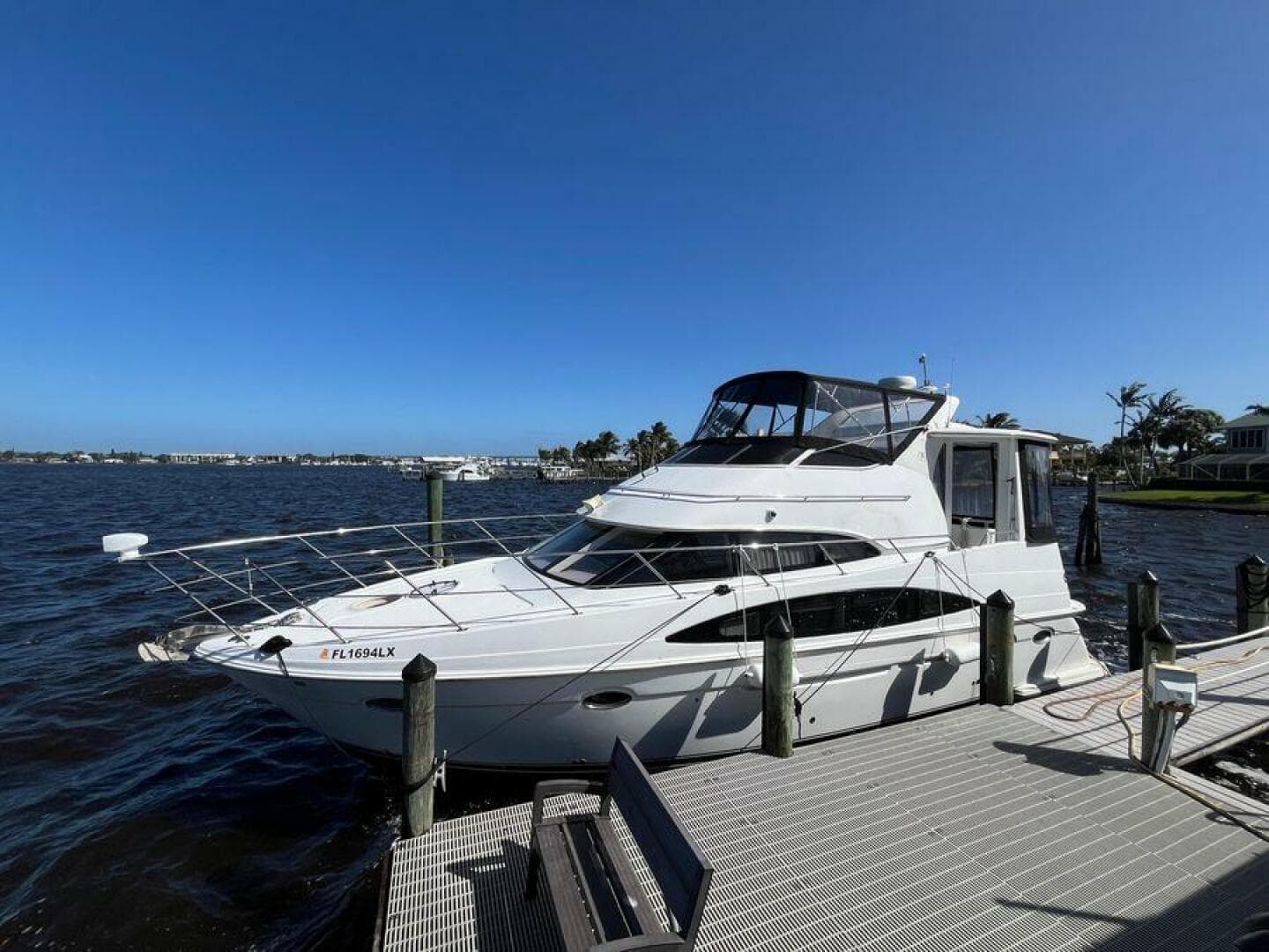 2000 Carver 396 Motor Yacht docked by a scenic waterfront.