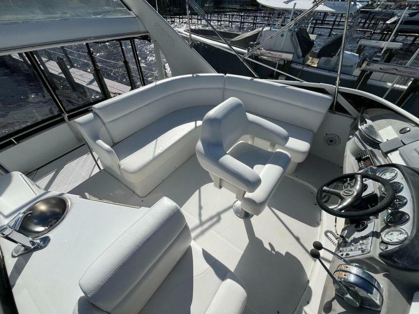 Spacious deck of 2000 Carver 396 Motor Yacht with white seating and control panel.