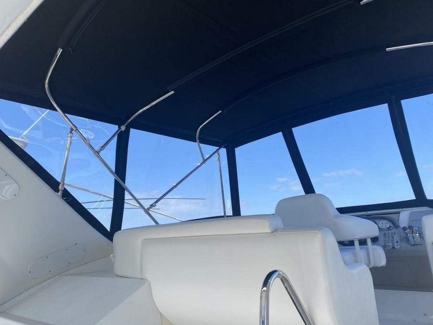 Interior view of 2000 Carver 396 Motor Yacht with white seating and large windows.