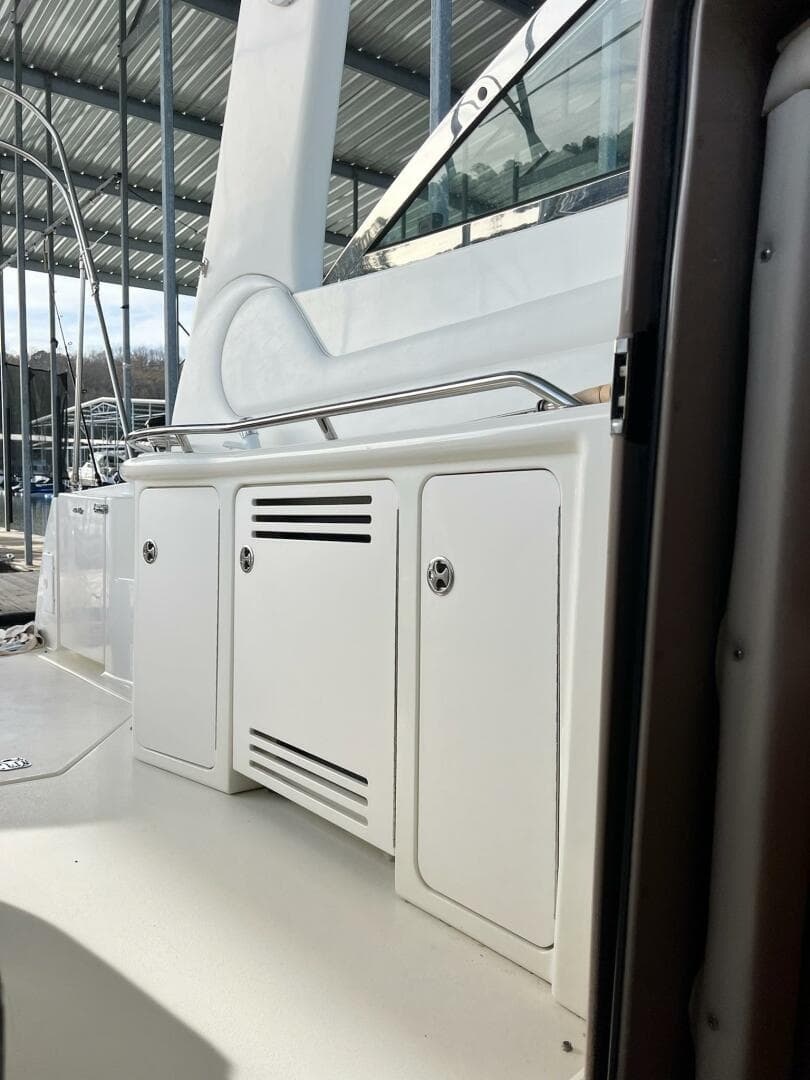 2001 Sea Ray 380 Sundancer yacht interior with white cabinetry and railing.
