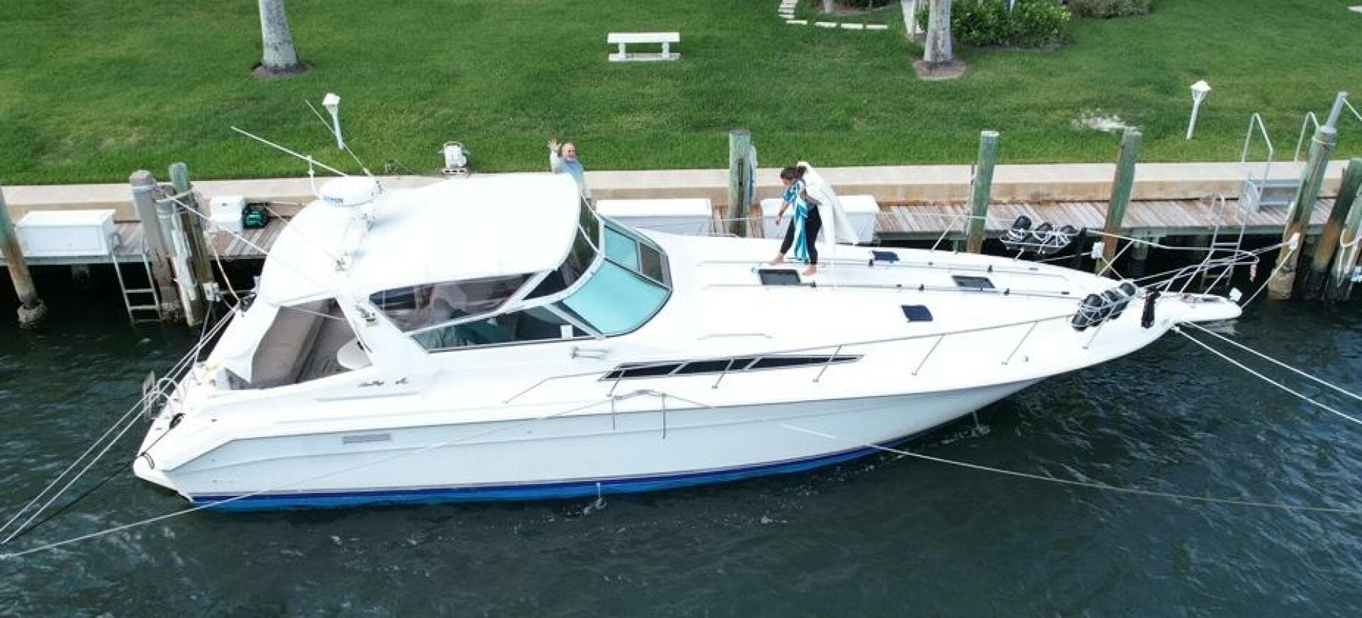 1993 Sea Ray 440 Sundancer yacht docked at marina, aerial view.