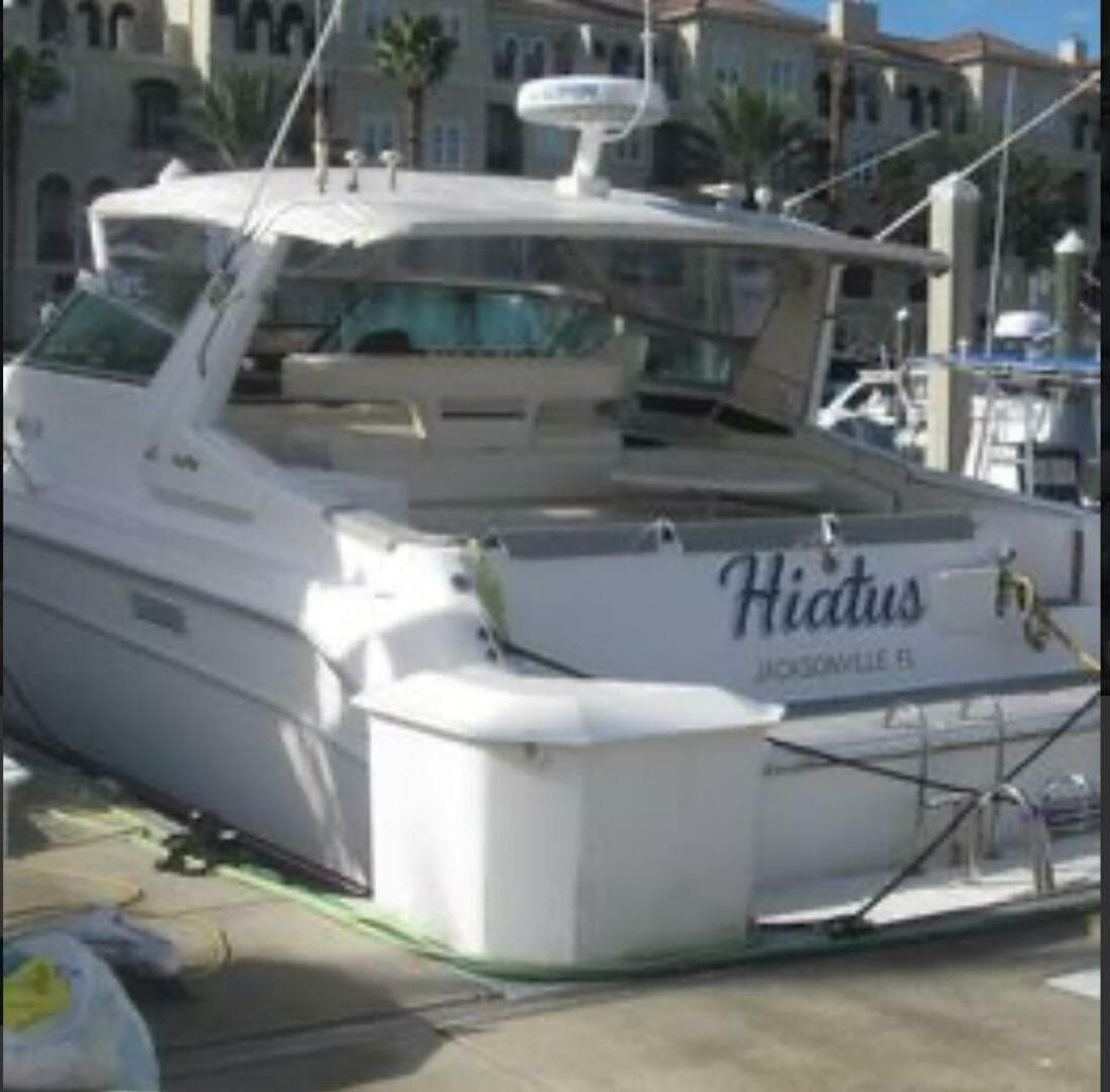 1993 Sea Ray 440 Sundancer yacht docked, named "Hiatus," in Jacksonville, Florida marina.