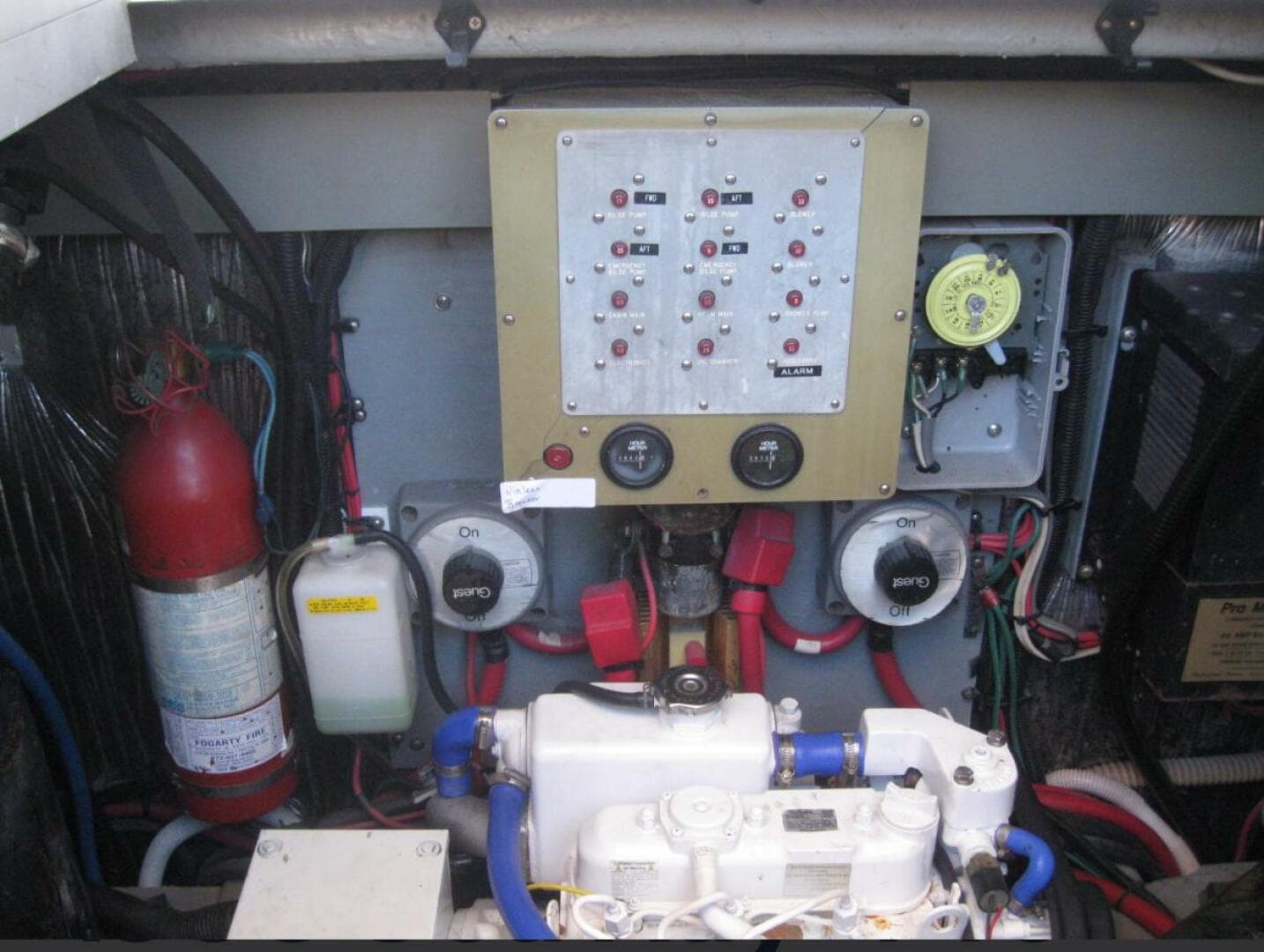 Engine room of 1993 Sea Ray 440 Sundancer with control panel and fire extinguisher.
