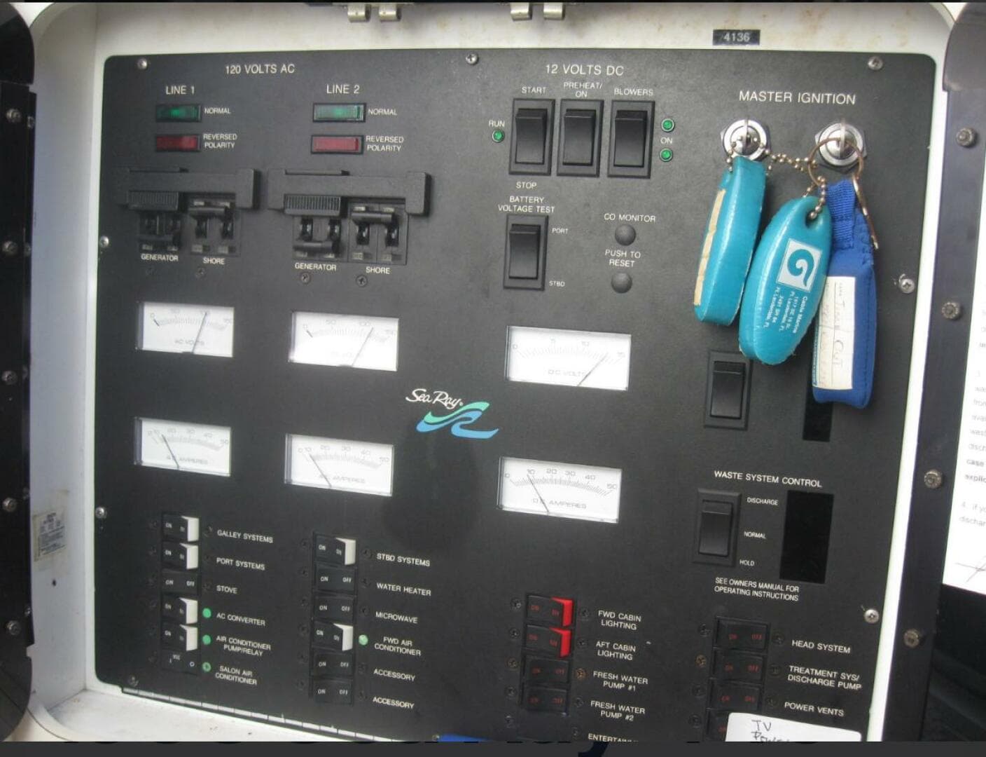 Control panel of a 1993 Sea Ray 440 Sundancer boat with ignition keys.