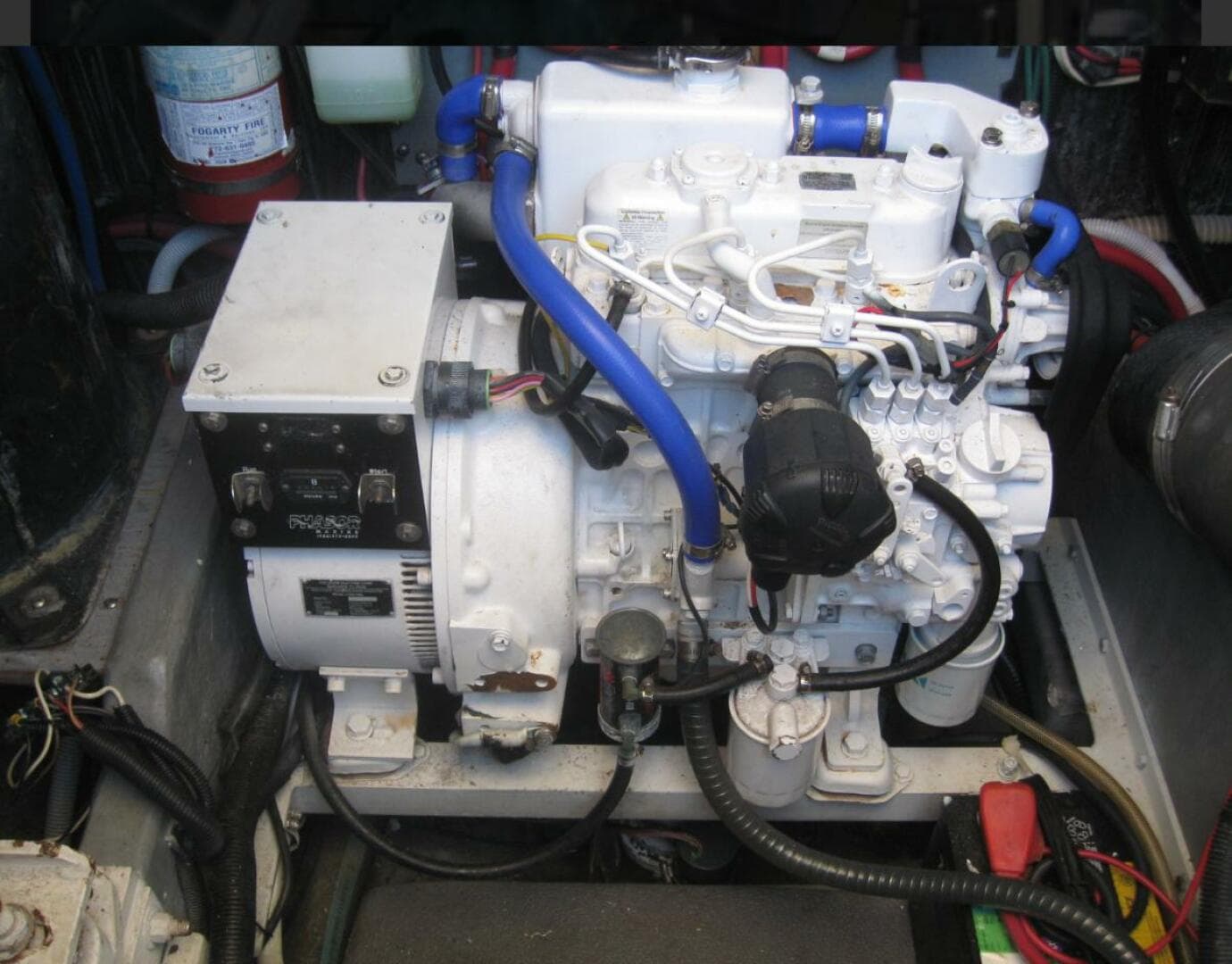Engine compartment of a 1993 Sea Ray 440 Sundancer with visible wiring and components.