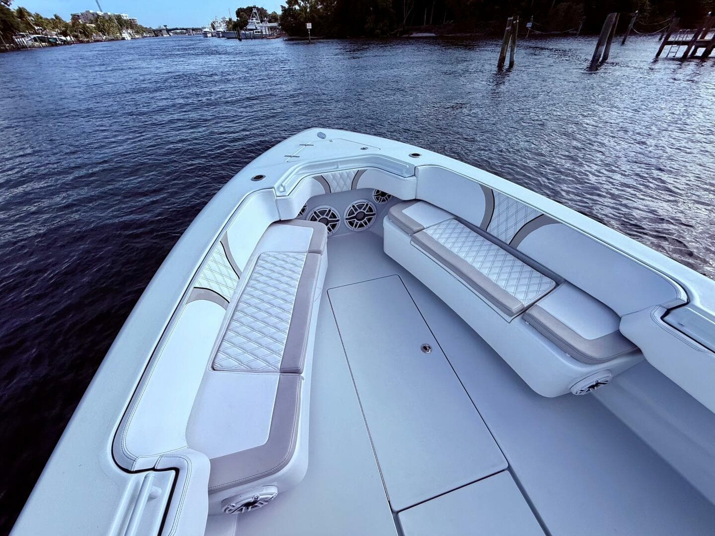 2024 Contender 39 ST boat interior with luxurious seating on a calm waterway.
