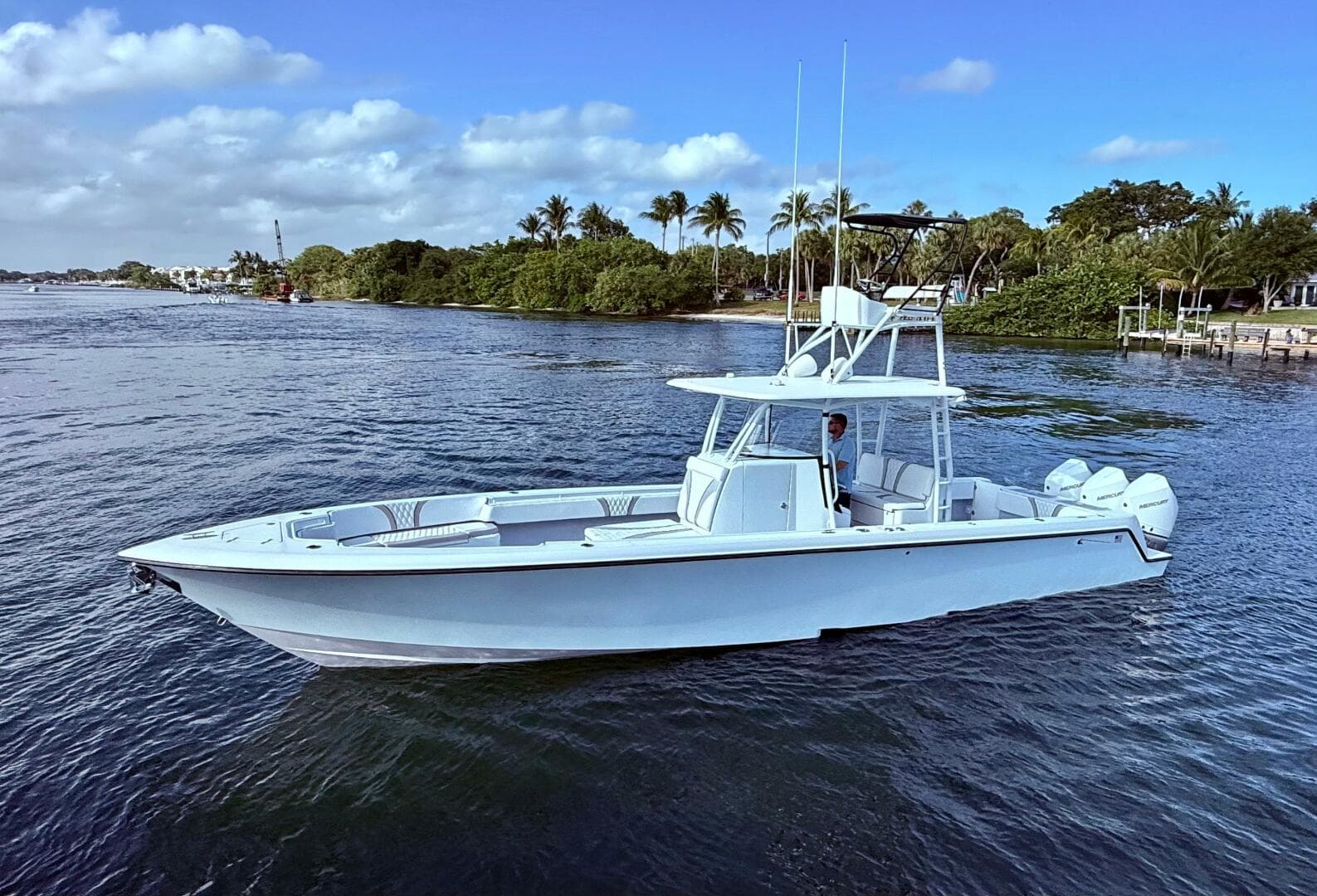 2024 Contender 39 ST boat on calm water with scenic background.