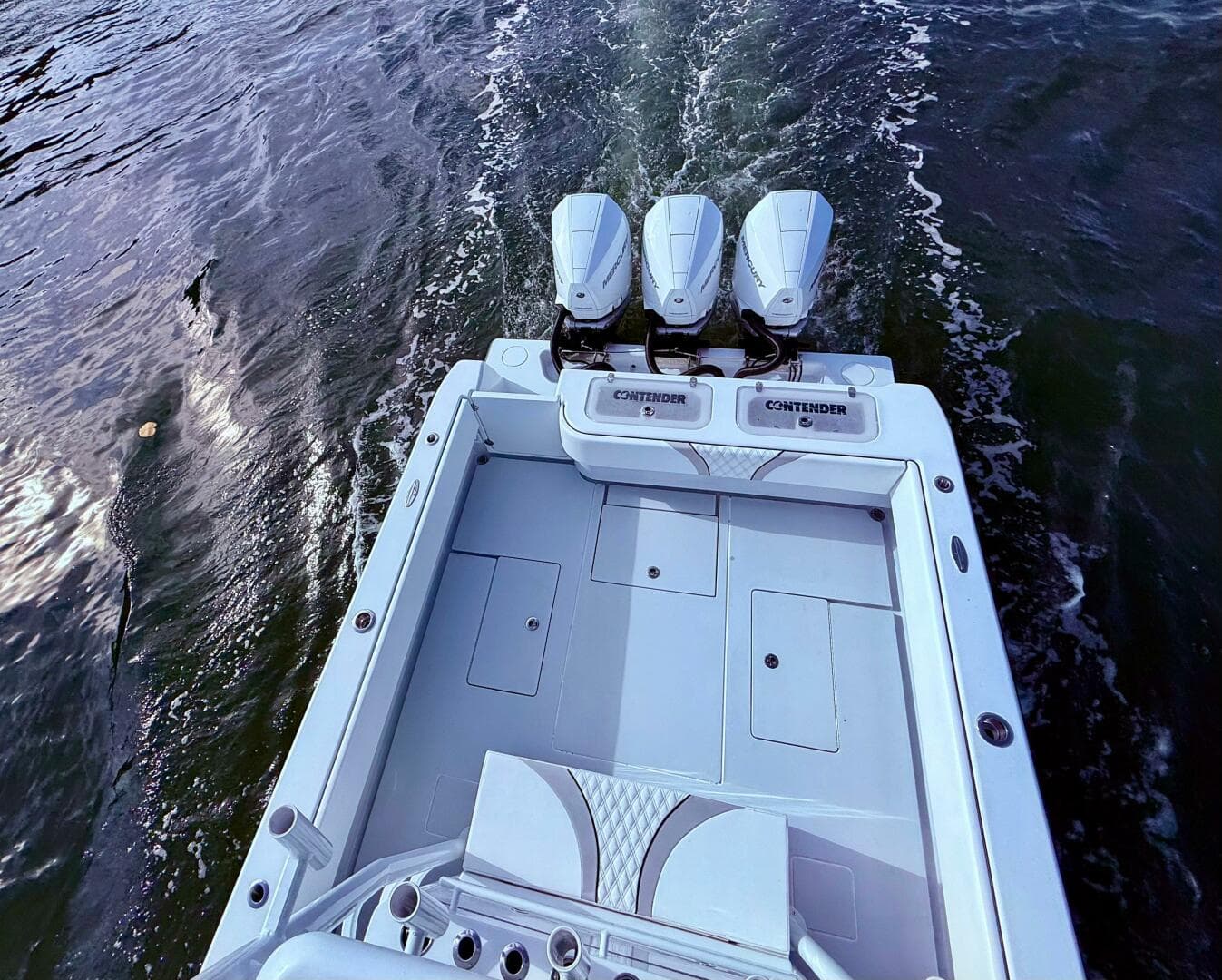 2024 Contender 39 ST boat with triple engines cruising on water.