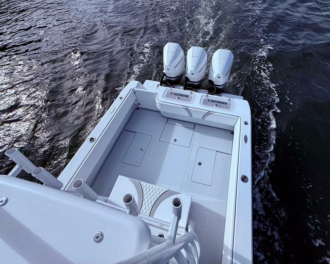 2024 Contender 39 ST boat with triple engines on water.