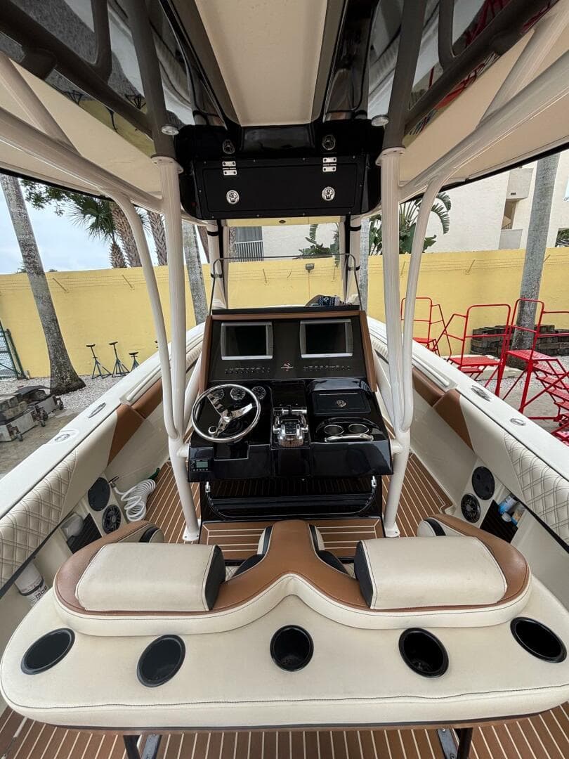 2013 Statement 35 Center Console boat interior with dual screens and steering wheel.