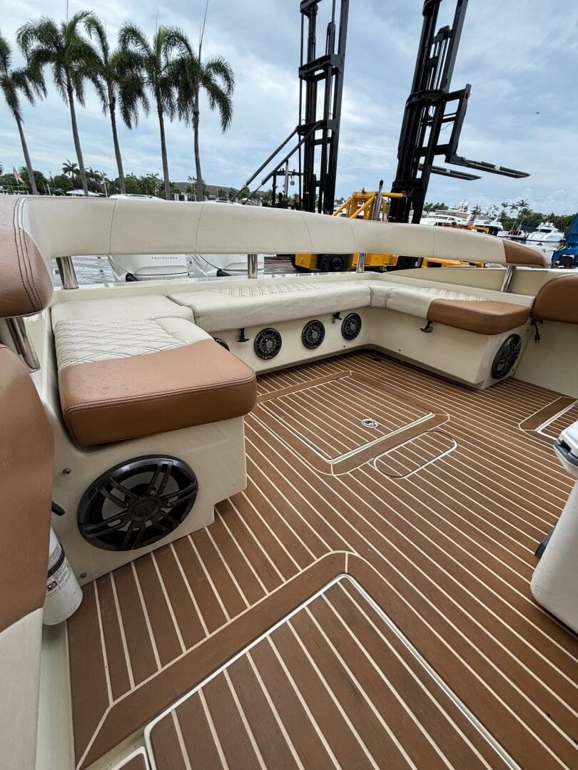 Luxurious 2013 Statement 35 Center Console boat interior with cushioned seating and speakers.