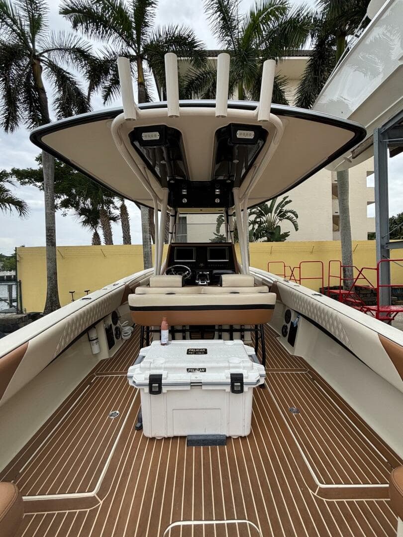 2013 Statement 35 Center Console boat with teak flooring and palm trees in the background.