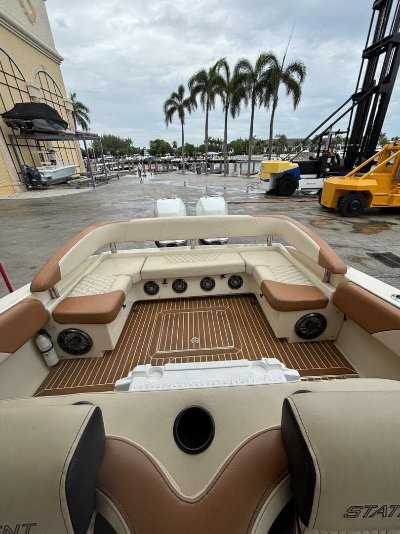 Luxurious 2013 Statement 35 Center Console boat interior with plush seating and teak flooring.
