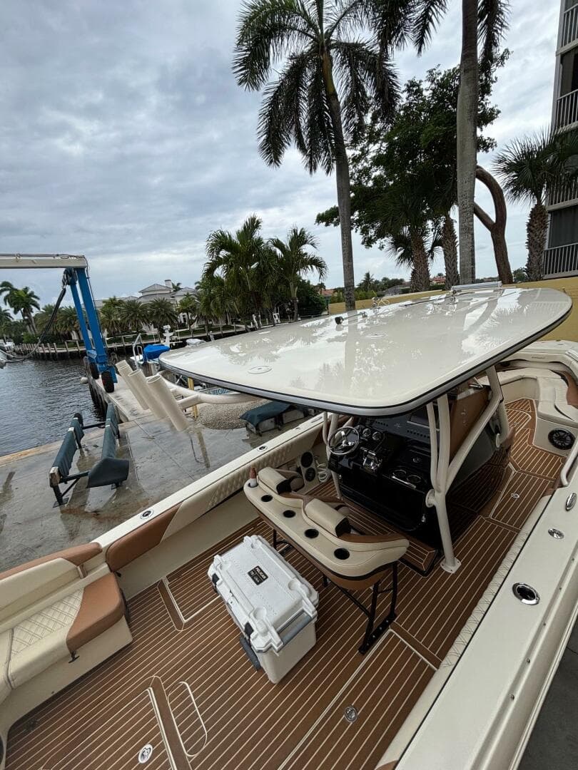 2013 Statement 35 Center Console boat docked, featuring sleek design and spacious deck.
