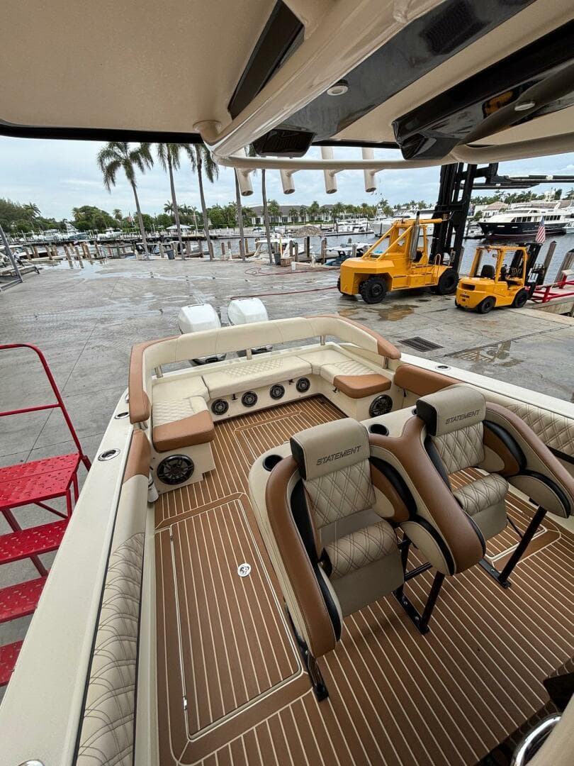 2013 Statement 35 Center Console boat with luxurious seating at a marina.