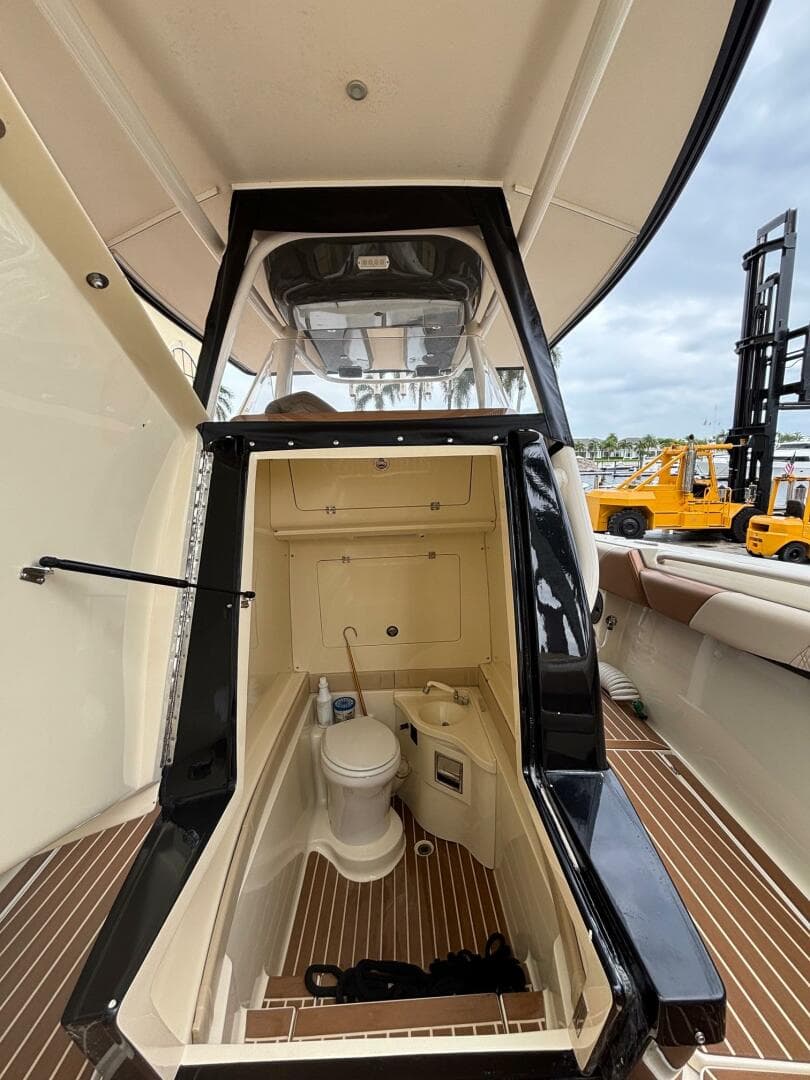 2013 Statement 35 Center Console boat interior with toilet and storage compartment.