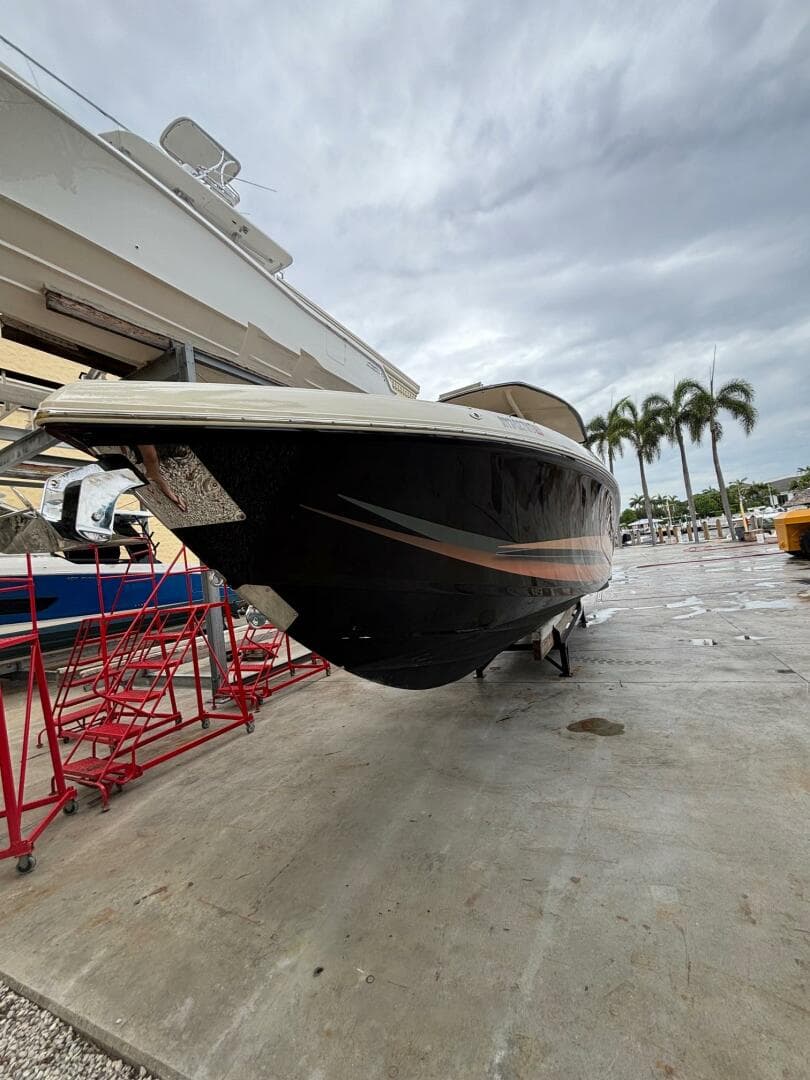2013 Statement 35 Center Console boat on dry dock with overcast sky.