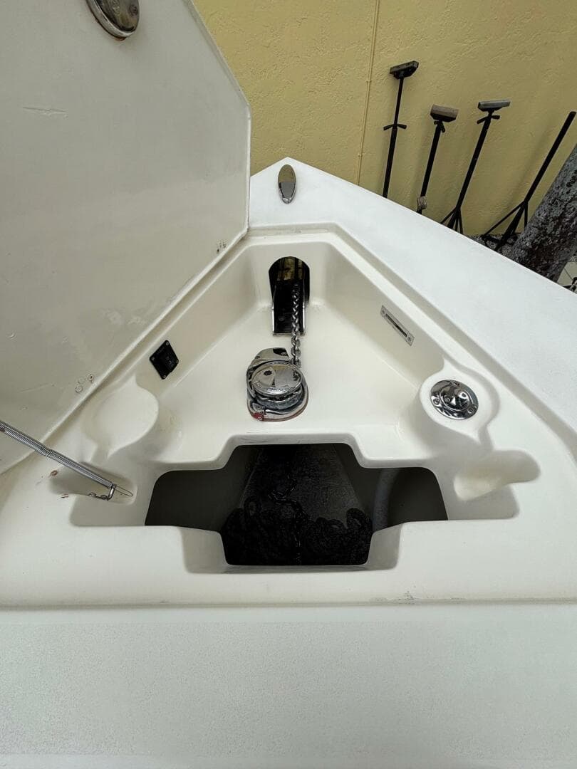 Anchor compartment of 2013 Statement 35 Center Console boat, featuring winch and chain storage.
