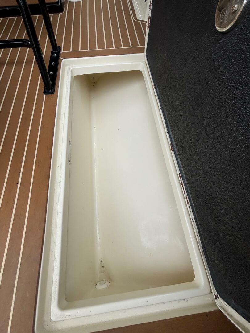 Open storage compartment on 2013 Statement 35 Center Console boat deck.