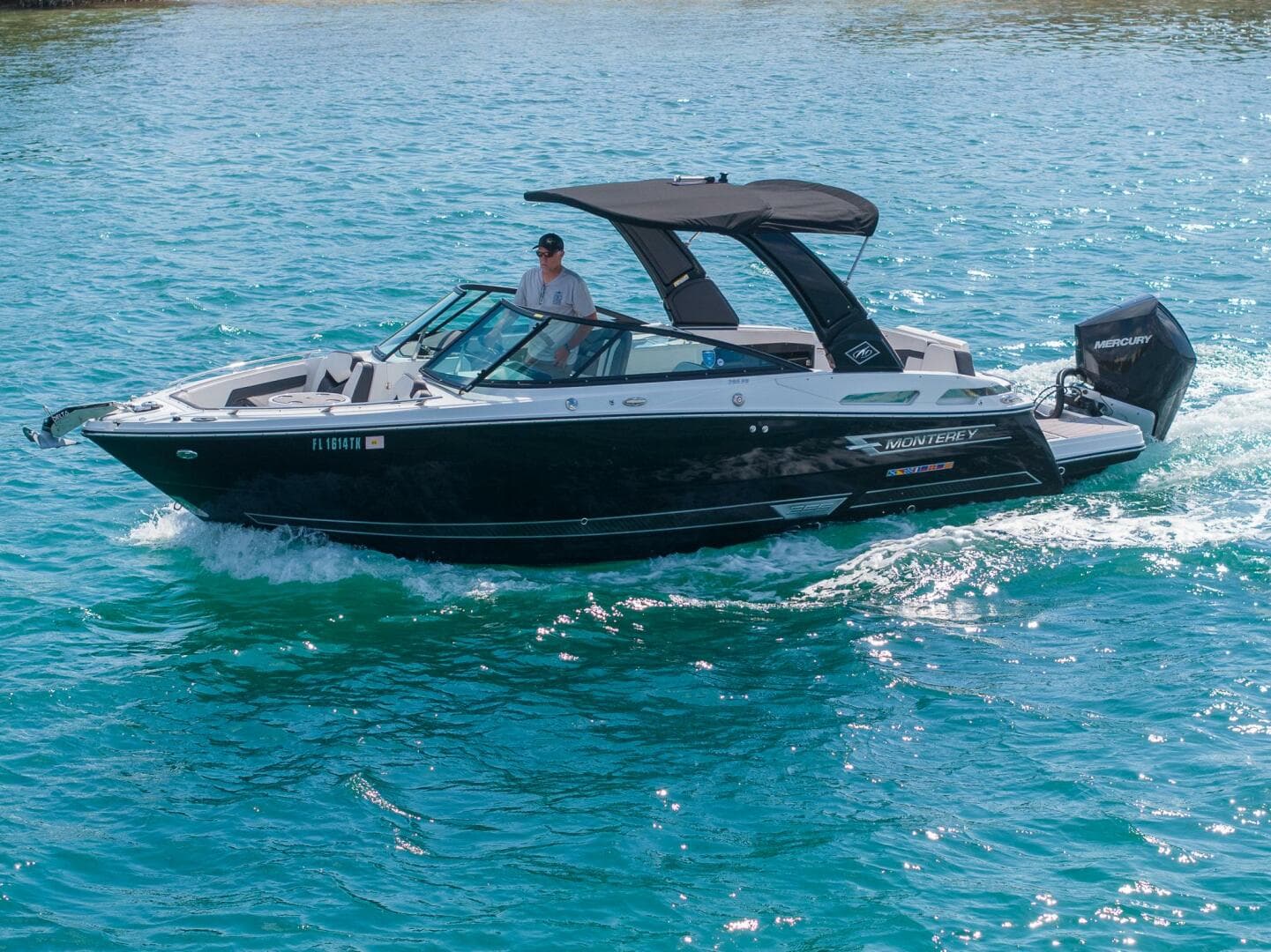 2023 Monterey 255 Super Sport boat cruising on clear blue water.