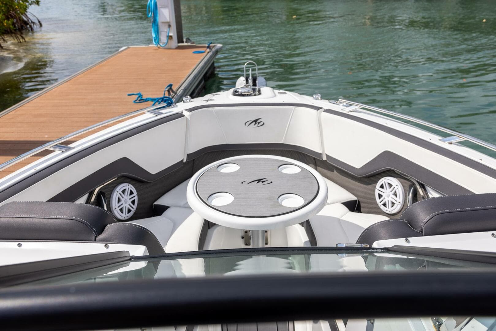 2023 Monterey 255 Super Sport boat interior with seating and table, docked by the water.