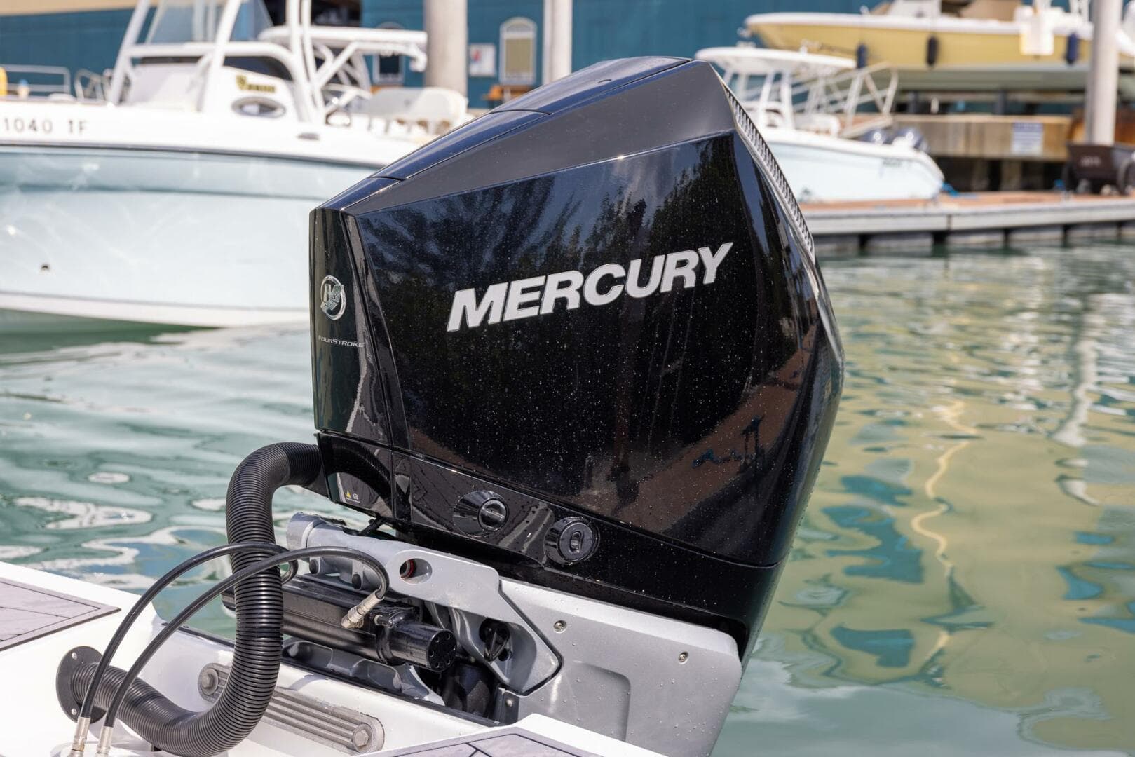 Outboard motor on 2023 Monterey 255 Super Sport boat at marina.