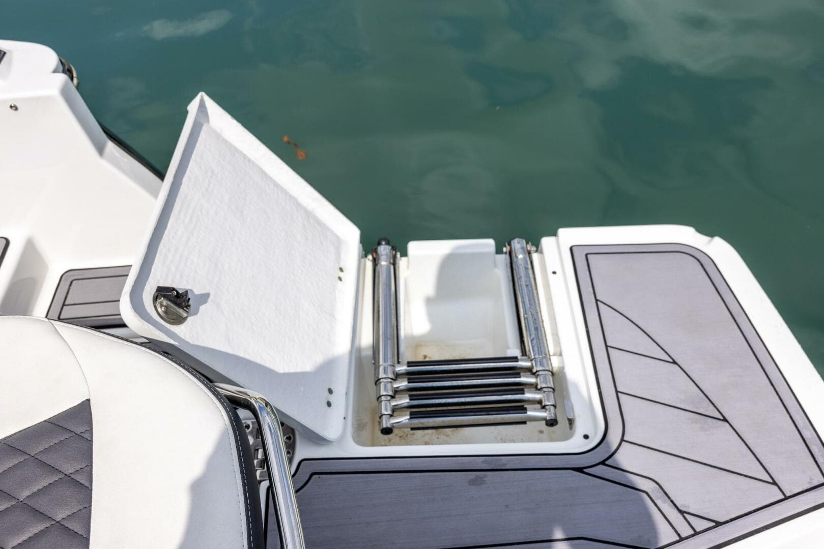 2023 Monterey 255 Super Sport boat ladder and deck detail by the water.
