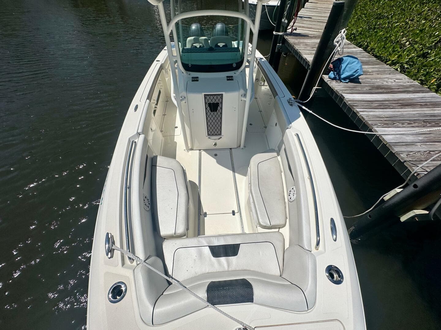 2019 Wellcraft 262 Fisherman boat docked, featuring spacious seating and sleek design.