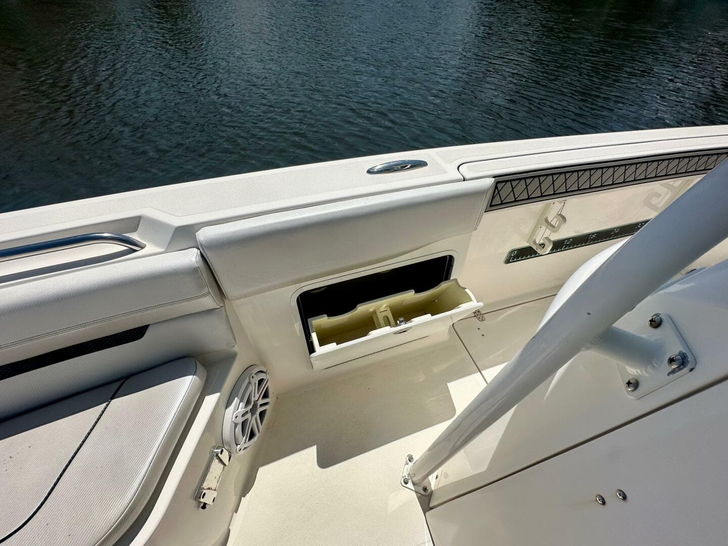 2019 Wellcraft 262 Fisherman boat interior with storage compartment and speaker.
