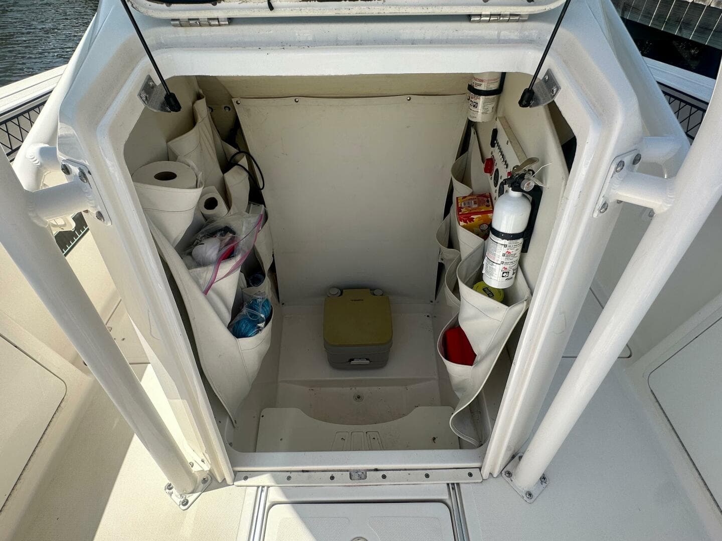 2019 Wellcraft 262 Fisherman storage compartment with organized supplies and safety equipment.