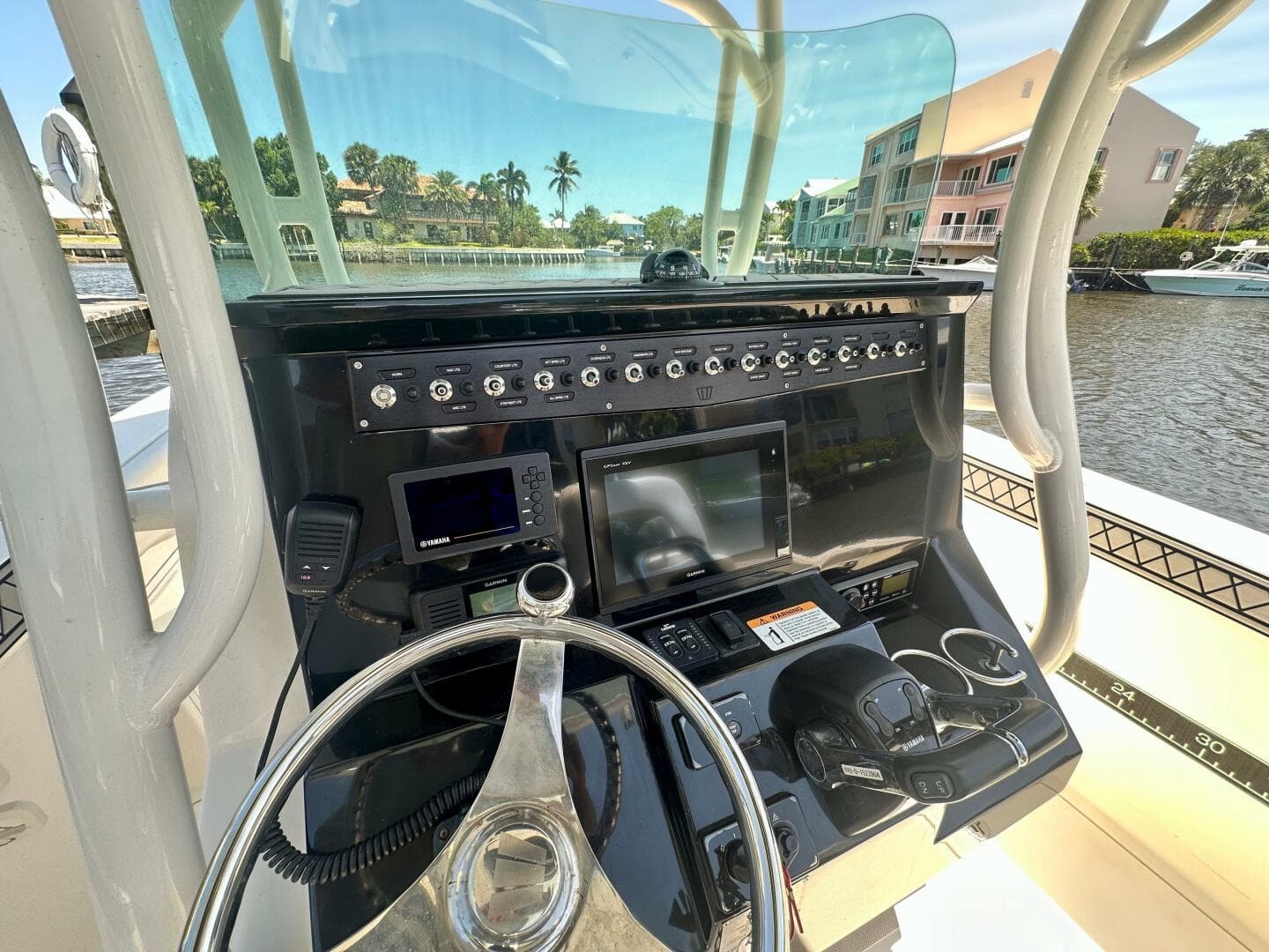 2019 Wellcraft 262 Fisherman boat console with steering wheel and navigation equipment.