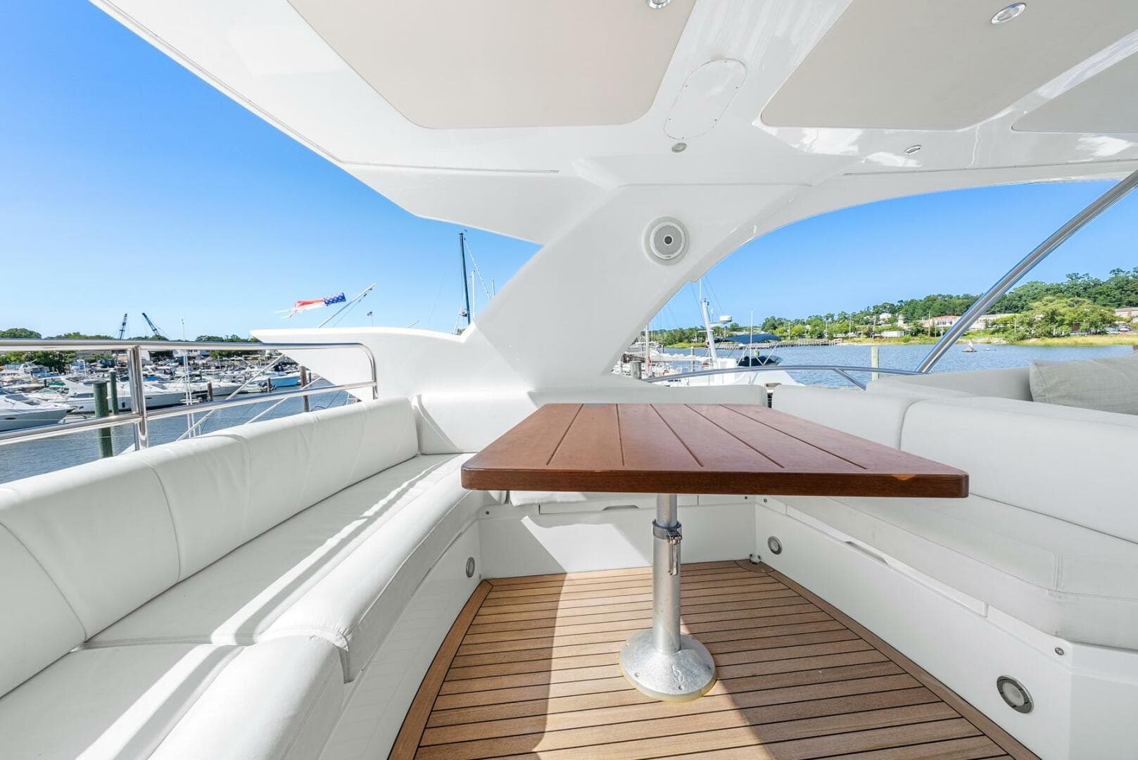 Luxurious Sunseeker Manhattan 65 yacht interior with elegant seating and wooden table, 2016 model.