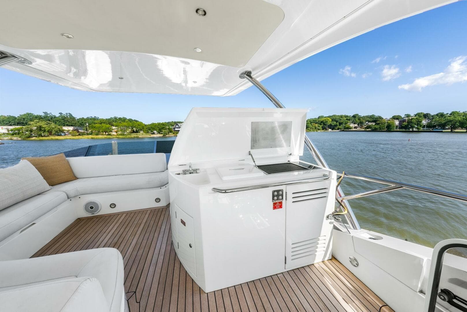 Luxurious 2016 Sunseeker Manhattan 65 yacht deck with seating and water view.
