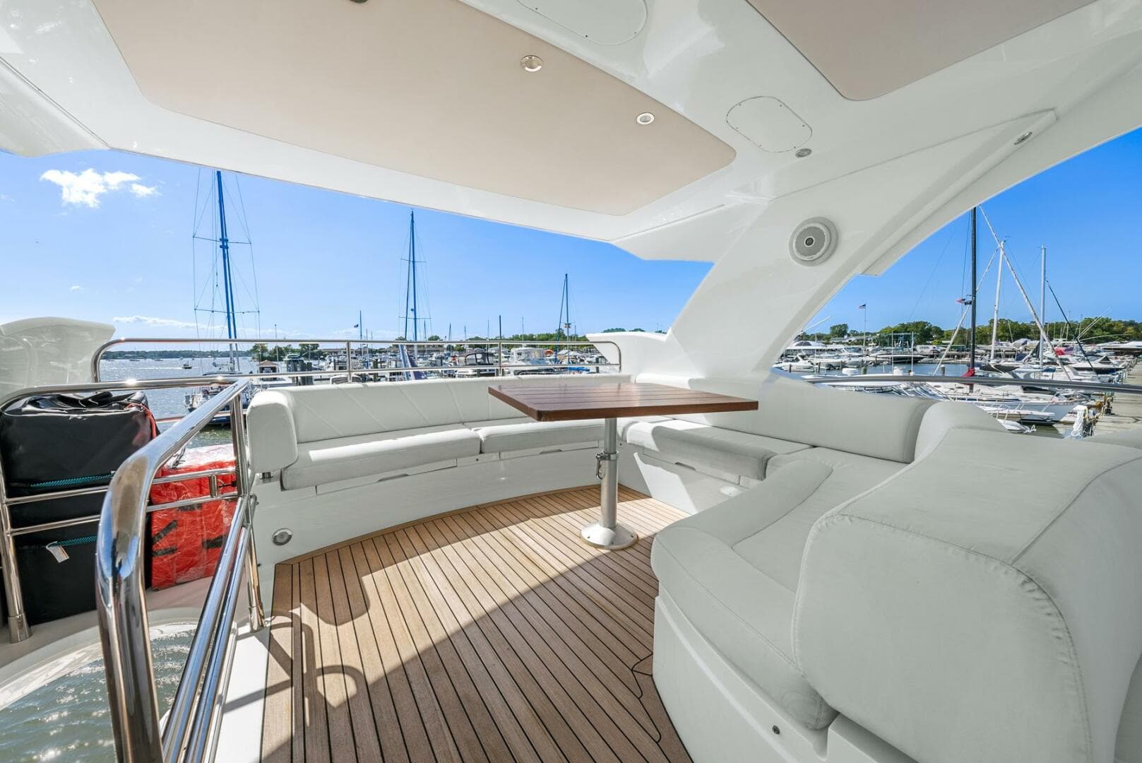 Luxurious 2016 Sunseeker Manhattan 65 yacht with spacious deck and marina view.