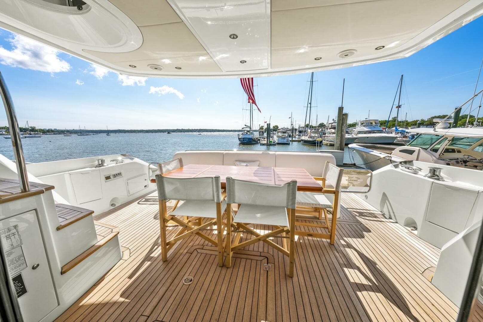 Sunseeker Manhattan 65 yacht deck with seating, overlooking marina, 2016 model.