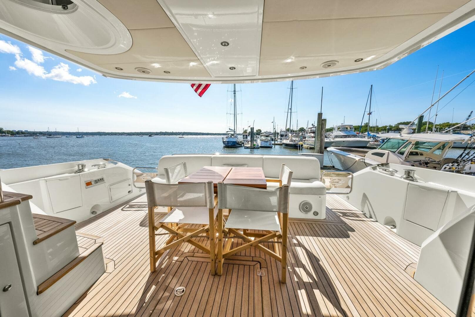 Luxury Sunseeker Manhattan 65 yacht deck with seating, overlooking marina, 2016 model.