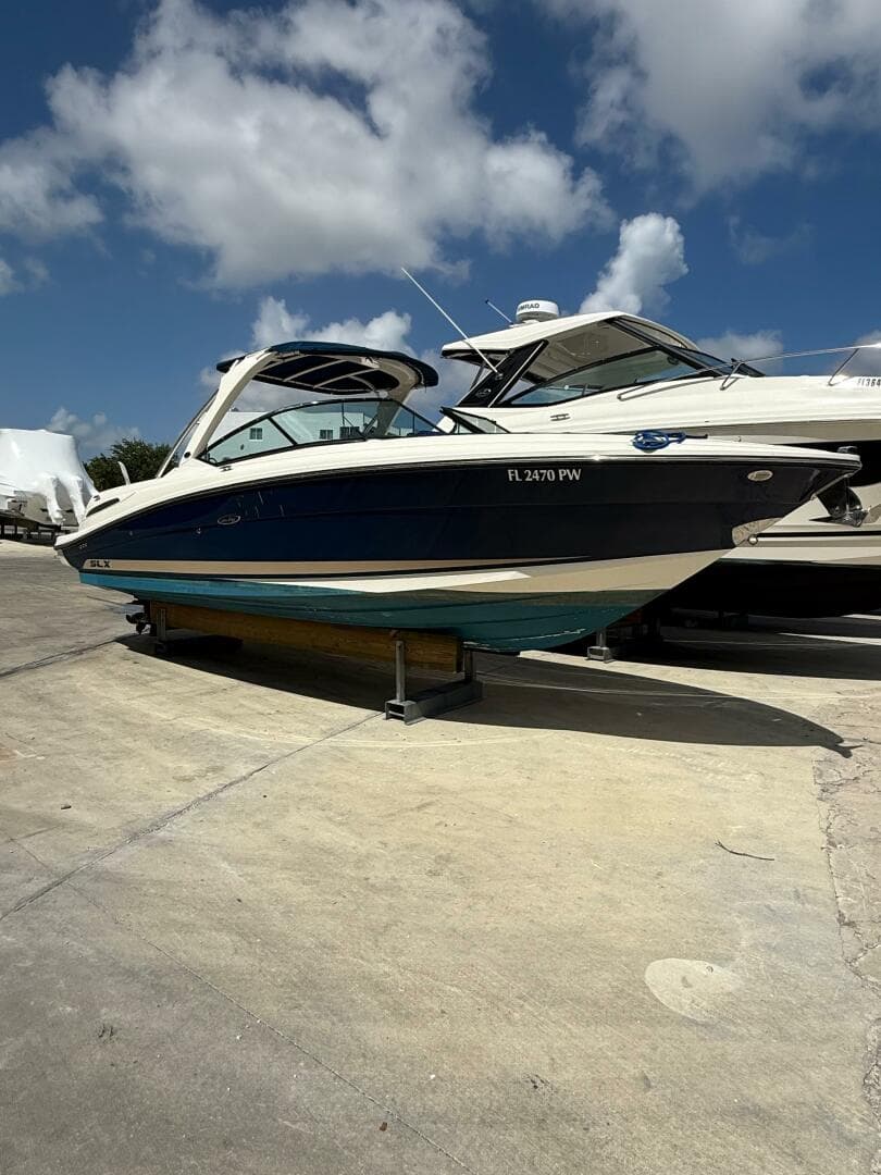 2014 Sea Ray 270 SLX boat on a sunny day at a marina.