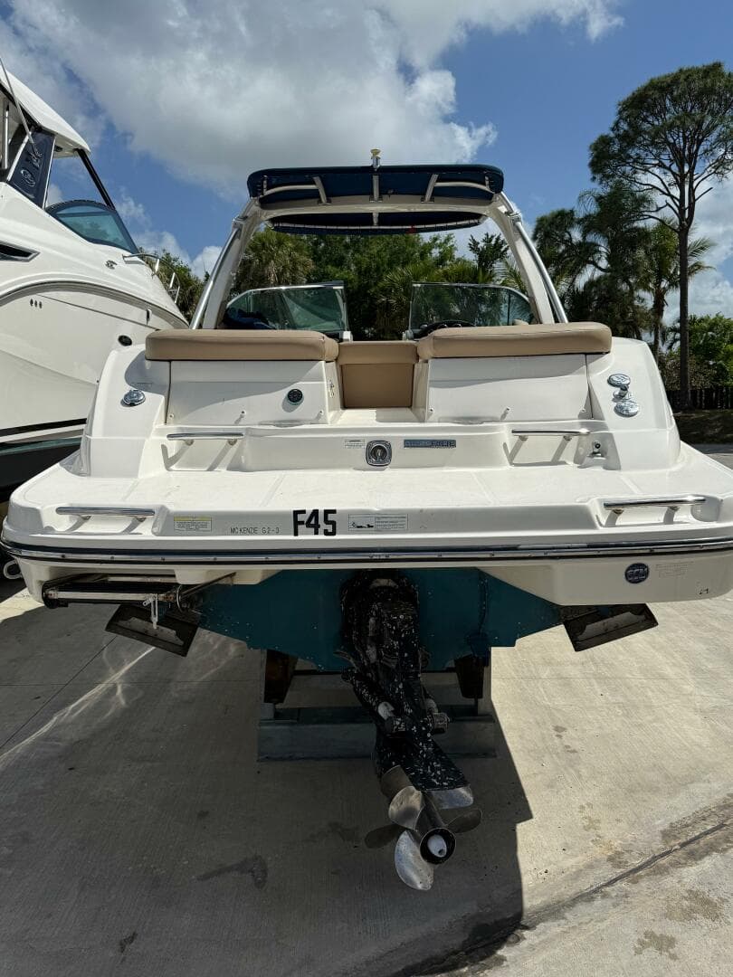 2014 Sea Ray 270 SLX boat, rear view, docked under a cloudy sky.