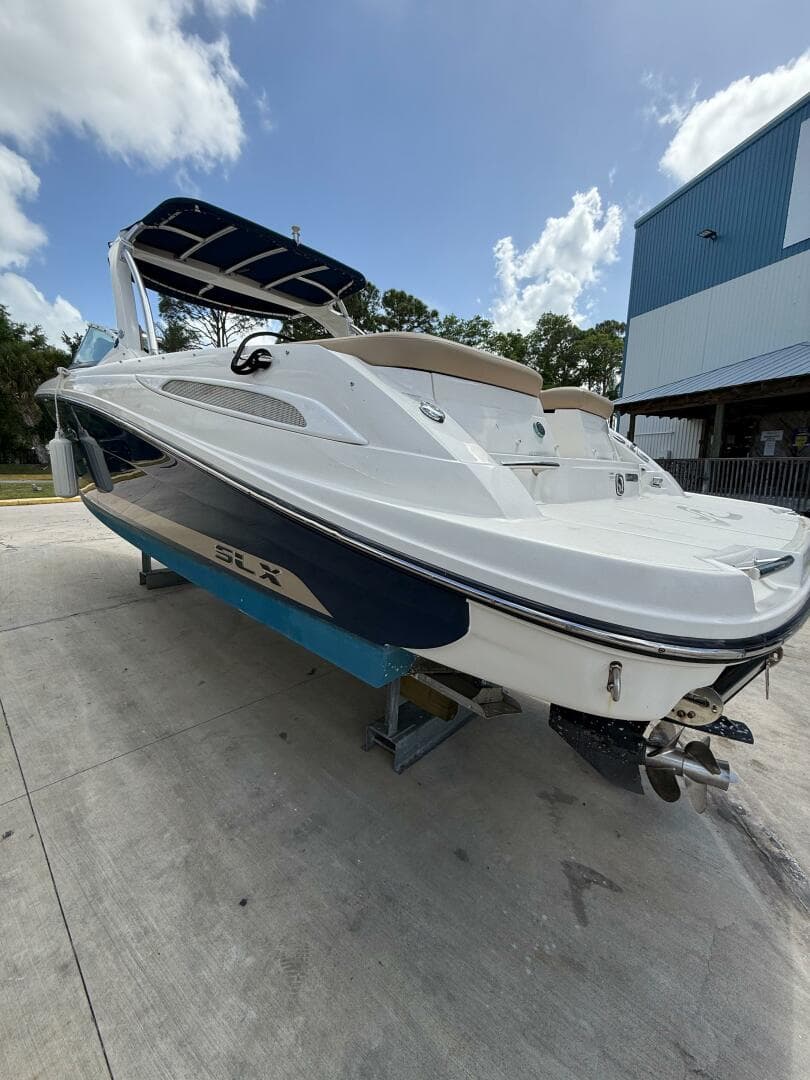 2014 Sea Ray 270 SLX boat on trailer, white and blue, parked outdoors.