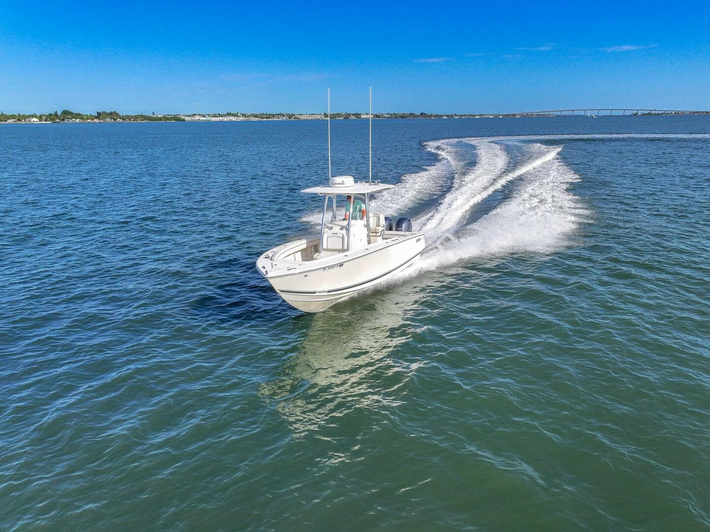 2018 Jupiter 26 FS boat cruising on open water under clear blue sky.