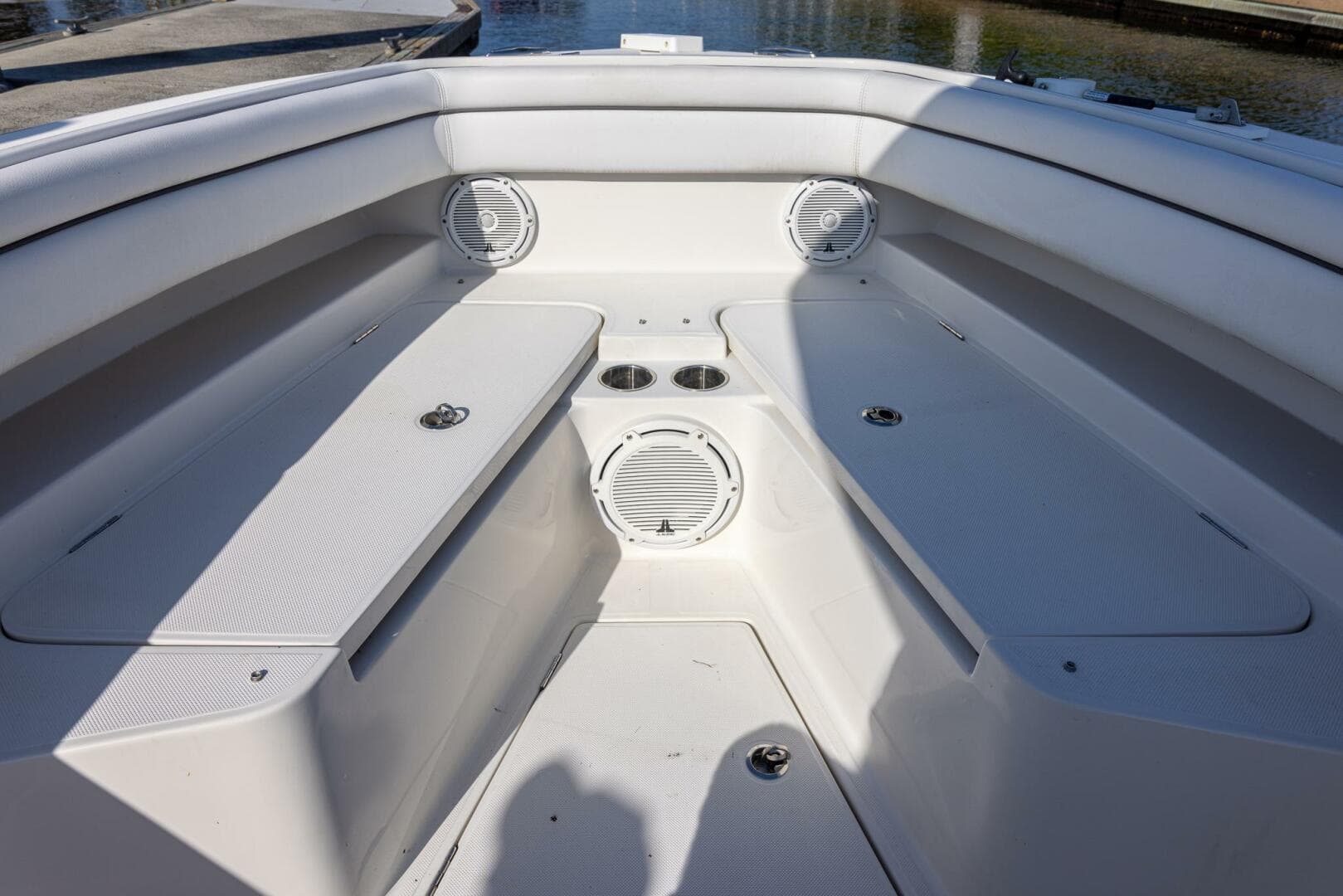 Bow seating area of 2018 Jupiter 26 FS boat with speakers and cup holders.