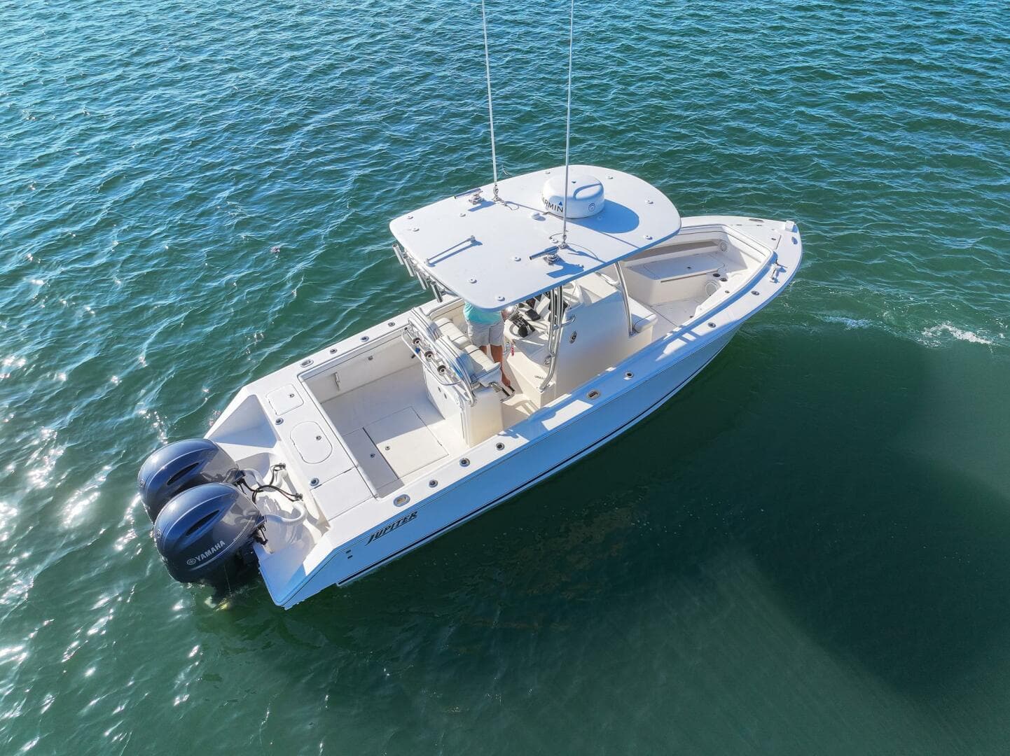 2018 Jupiter 26 FS boat on water, aerial view, twin engines, white hull.