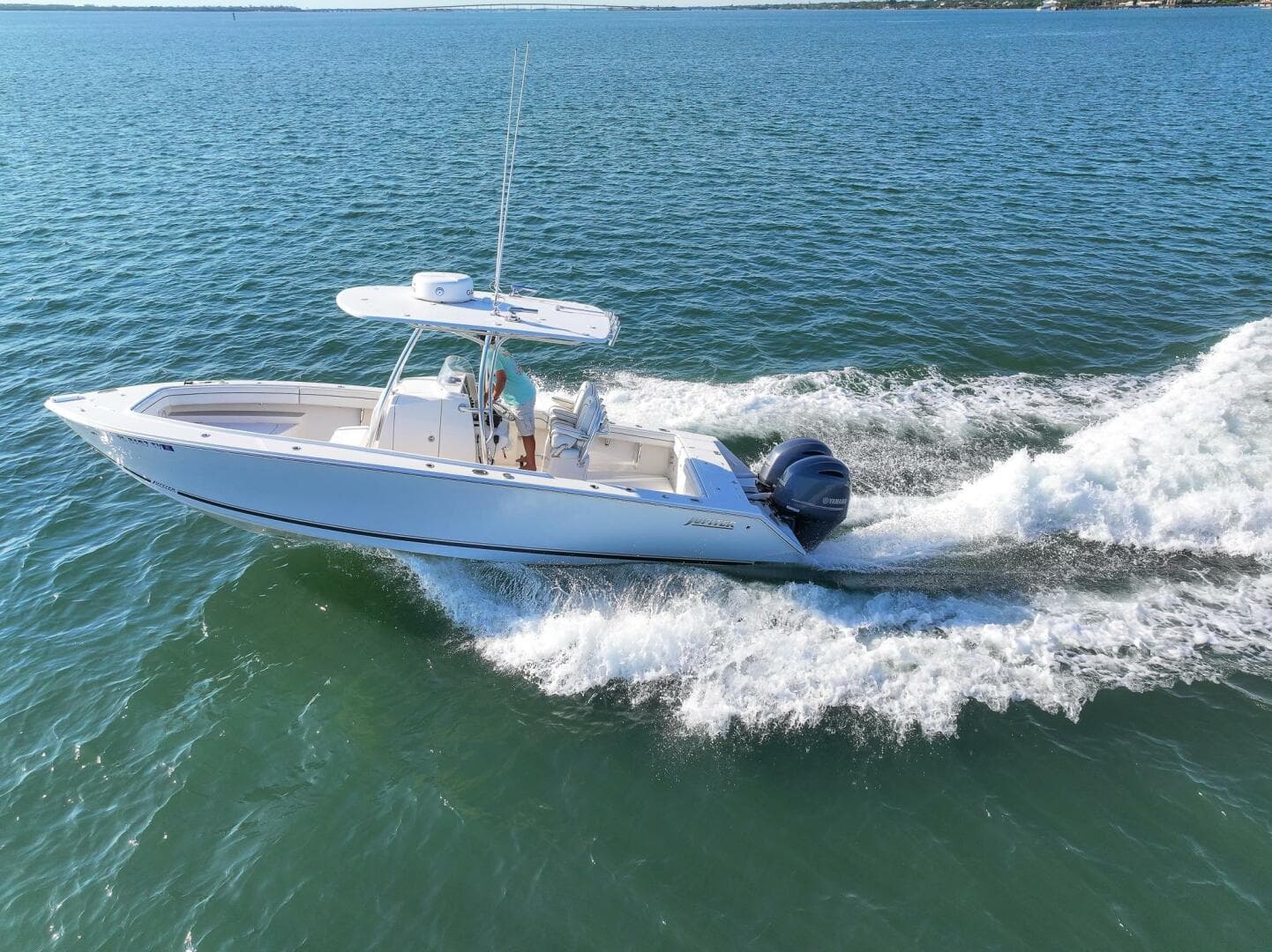 2018 Jupiter 26 FS boat cruising on open water, creating a wake.