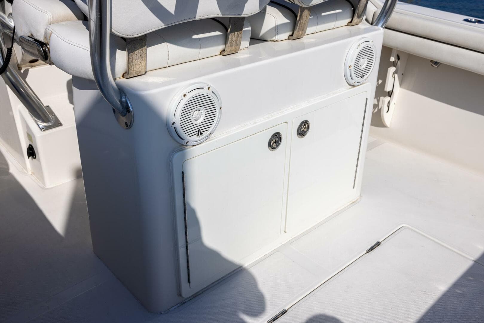 2018 Jupiter 26 FS boat interior with white seating and built-in speakers.